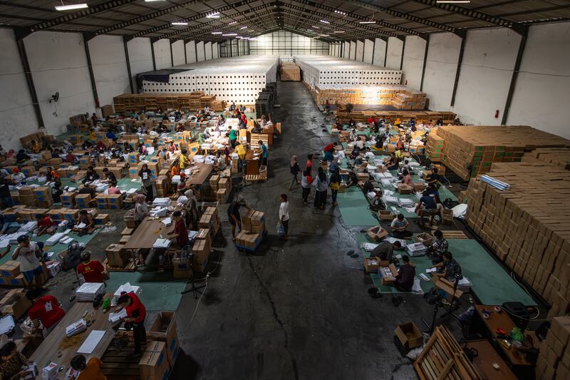 Workers sort and fold ballot papers at the general elections logistics warehouse in Surabaya, Indonesia. Getty Images