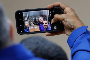 From left, U.S. astronaut Jessica Meir, Russian cosmonaut Oleg Skripochka, and United Arab Emirates astronaut Hazza Al Mansouri, members of the main crew to the International Space Station (ISS), take a selfie photo during a news conference in Russian leased Baikonur cosmodrome, Kazakhstan, Tuesday, Sept. 24, 2019. The new Soyuz mission to the International Space Station (ISS) is scheduled on Wednesday, Sept 25. (AP Photo/Dmitri Lovetsky)