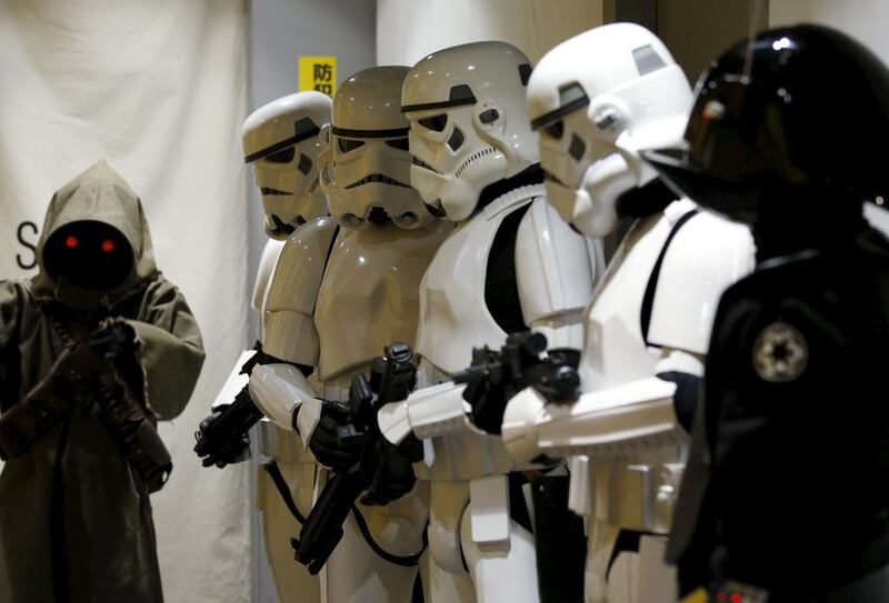 Store staff dressed up as Stormtrooper, Jawa left, and Death Star Gunner right. Toru Hanai / Reuters