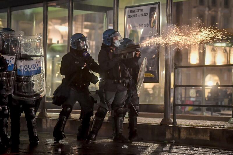 Riot police fire tear gas in Turin. AP Photo