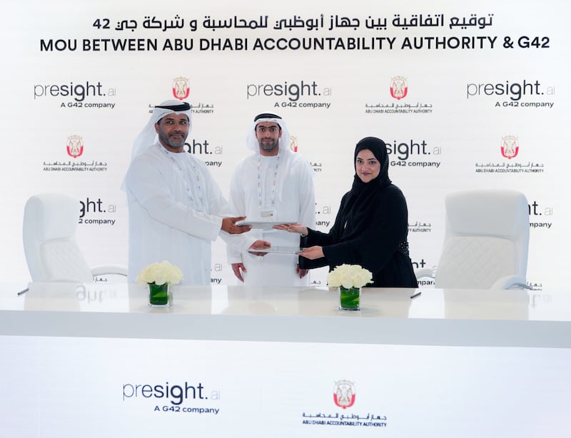 Haifa Al Balooshi, ADAA’s director of information technology, right, and Adel Al Sharji, chief operating officer of Presight.ai, left, during the signing ceremony at the Abu Dhabi pavilion at Gitex Global Week in Dubai on Wednesday. Photo: ADAA