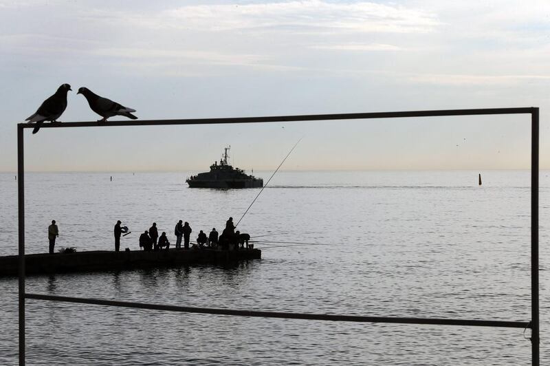 People fish on January 28, 2014, in the Black Sea near Sochi, Russia, where the Olympic Winter Games will take place February 7-23, 2014. Anatoly Maltsev / EPA photo