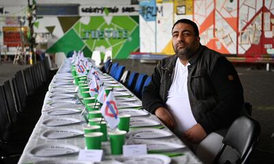 Former Grenfell Tower resident Nabil Choucair, who lost six members of his family in the Grenfell fire, sits at an empty party table. EPA