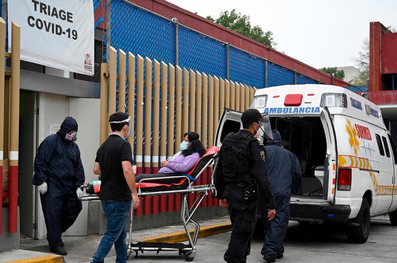 Paramedics move a patient suspected of having the novel coronavirus, at the COVID-19 triage area of the General Hospital in Mexico City. AFP