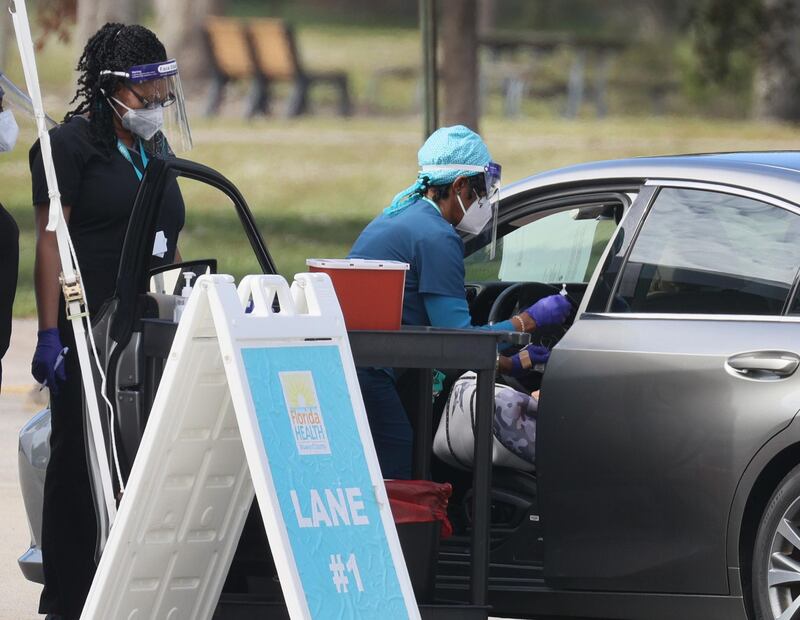 A healthcare worker with the Florida Department of Health in Broward prepares to administer a Covid-19 vaccine at a drive-thru vaccination site at Vista View Park in Davie, Florida. Joe Raedle / Getty Images / AFP