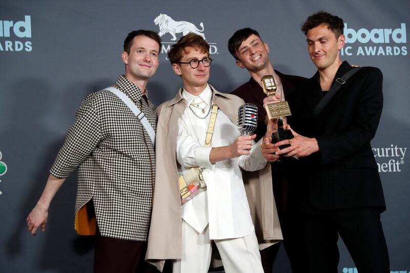 Members of Glass Animals pose with the award for Top Rock Artist. Reuters