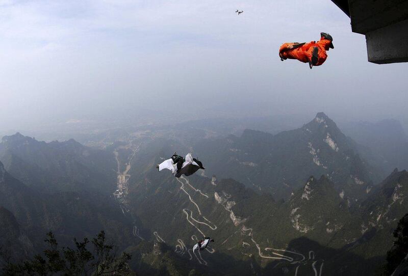 Wingsuit flying athletes shown during a jump over China's Tianmen Mountain during the Red Bull wingsuit flying China Grand Prix on Sunday. China Daily / Reuters