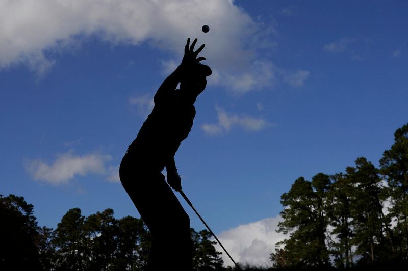 Tiger Woods catches a ball from his caddie before teeing off on the 16th hole at Augusta National during a practice round for the Masters. AP Photo