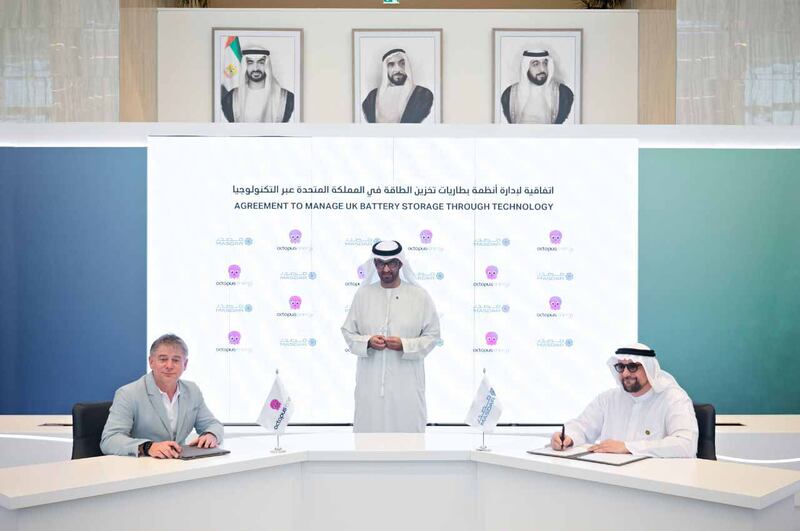 Dr Sultan Al Jaber, Minister of Industry and Advanced Technology and chairman of Masdar, oversees the signing of a deal by Mohamed Al Ramahi, chief executive of Masdar, right, and Greg Jackson, chief executive and founder of Octopus Energy Group, in Abu Dhabi. Photo: Octopus Energy Group