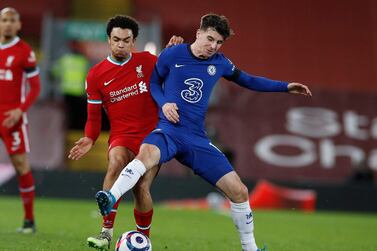 Chelsea's Mason Mount, right, challenges for the ball with Liverpool's Trent Alexander-Arnold during the English Premier League soccer match between Liverpool and Chelsea at Anfield stadium in Liverpool, England, Thursday, March 4, 2021. (Phil Noble, Pool via AP)