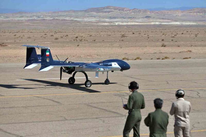 Technicians observe an aerial vehicle's performance. AFP