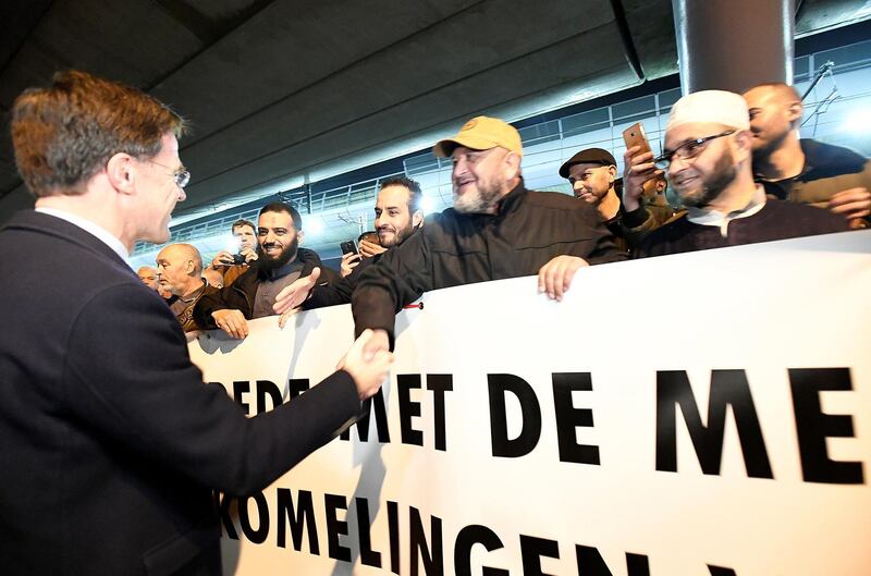 Dutch Prime Minister Mark Rutte shakes hands with members of a Muslim community during a silent march in Utrecht in honour of the people wounded or killed in an attack on a tram on Monday, in Utrecht, Netherlands March 22, 2019.  REUTERS/Piroschka Van De Wouw