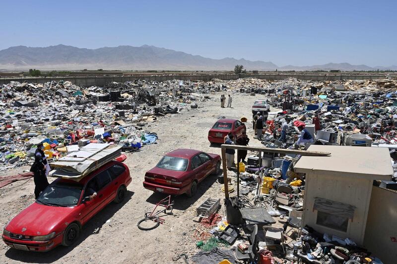 People select items at a recycling workshop near the Bagram Air Base. AFP