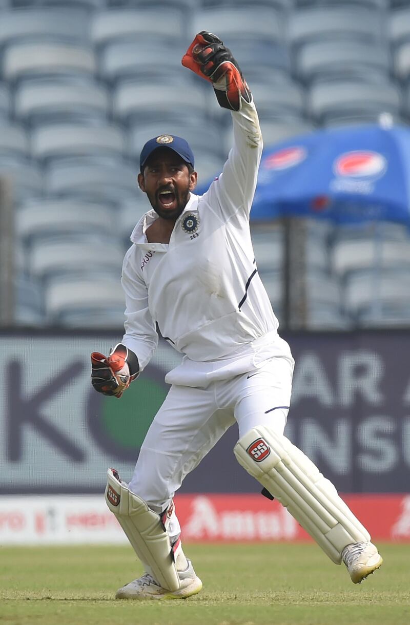 India keeper Wriddhiman Saha celebrates after taking catch of Theunis de Bruyn down the leg side. AFP
