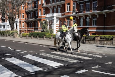 Two mounted police officers ride their horses across the famous Abbey Road crossing as a Highways Maintenance team take advantage of the Covid-19 lockdown to refresh the markings. Getty Images