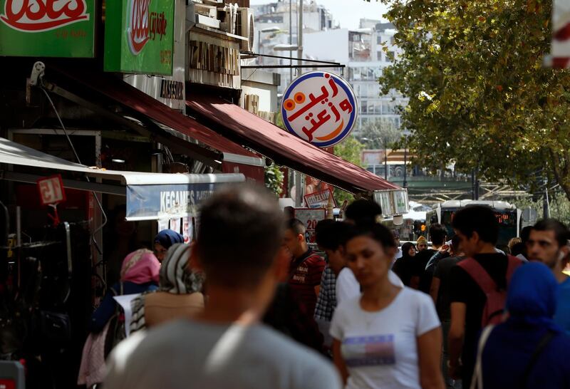 People walk past Syrian restaurants in the Istanbul neighborhood of Aksaray, where many Syrians live. Syrians say Turkey has been detaining and forcing some Syrian refugees to return back to their country the past month. The expulsions reflect increasing anti-refugee sentiment in Turkey, which opened its doors to millions of Syrians fleeing their country's civil war.  AP Photo