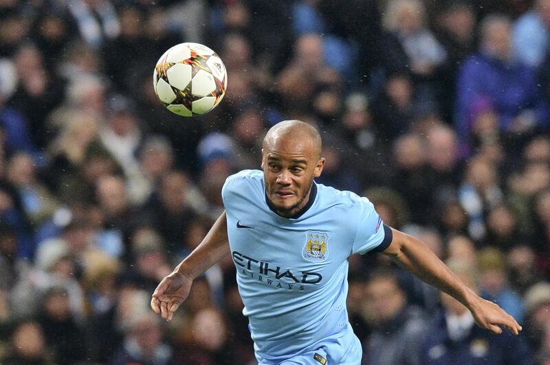 Manchester City's Belgian defender Vincent Kompany heads the ball during the UEFA Champions League Group E football match between Manchester City and Bayern Munich at the Etihad Stadium in Manchester, northwest England, on November 25, 2014. AFP PHOTO / PAUL ELLIS (Photo by PAUL ELLIS / AFP)
