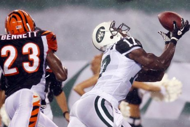 Plaxico Burress, right, is starting to catch on with his new team, the New York Jets.