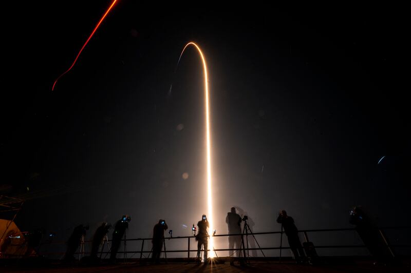 Carrying the crew's capsule, the Falcon 9 rocket lights up the sky over Cape Canaveral. AFP