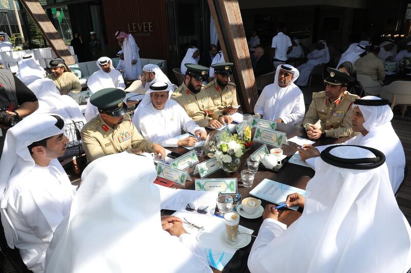 Dubai police officials discussing new techniques for licence plates