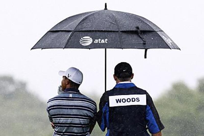 Fans wonder when Tiger Woods, left, will step out to play.