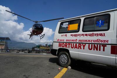 A helicopter carrying the body of US extreme skier, Hilaree Nelson, lands at a hospital in Kathmandu, Nepal. AP