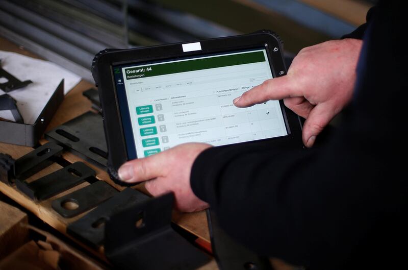 Ronny Mucha uses a new tablet computer for his work at the machine-building company Zemmler Siebanlagen in Massen, Germany, March 22, 2018. Picture taken March 22, 2018.  To match special report GERMANY-DIGITAL/GAP  REUTERS/Hannibal Hanschke