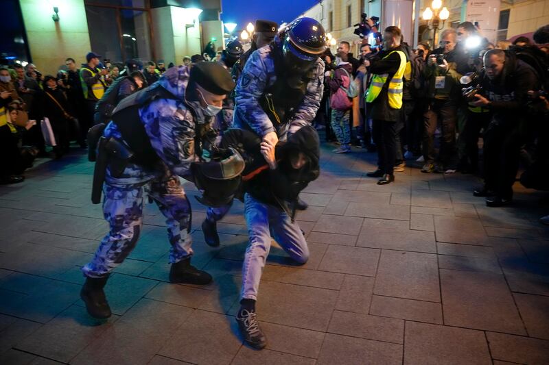 Riot police detain a demonstrator during a protest. AP