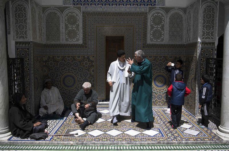 Men gather at the Moulay Idriss II mausoleum in the 9th century walled medina in the ancient Moroccan city of Fez on April 11, 2019. AFP