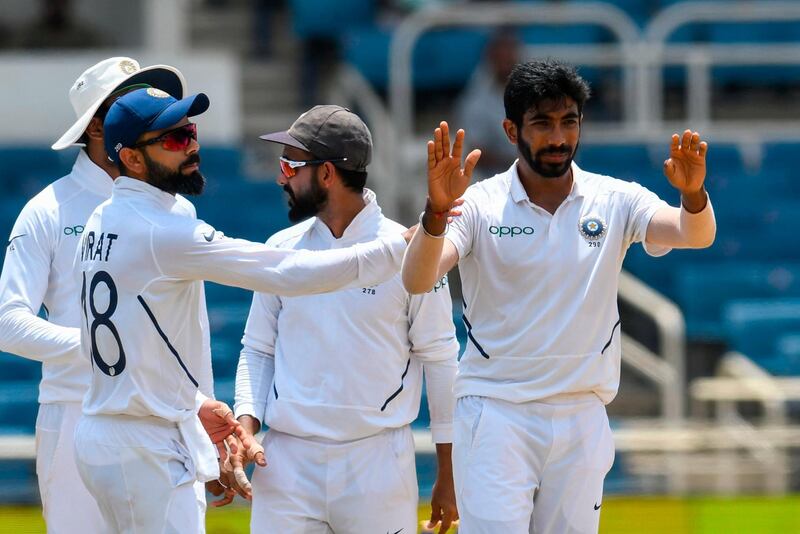 Virat Kohli (L) and Jasprit Bumrah (R) of India celebrates the dismissal of Jermaine Blackwood of West Indies during day 4 of the 2nd Test between West Indies and India at Sabina Park, Kingston, Jamaica, on September 2, 2019. / AFP / Randy Brooks
