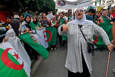 Algerian demonstrators carrying national flags chant slogans as they take part in a rally in the streets of the capital Algiers ahead of presidential election on December 12, five months into a political vacuum left after longtime leader Abdelaziz Bouteflika resigned. AFP 