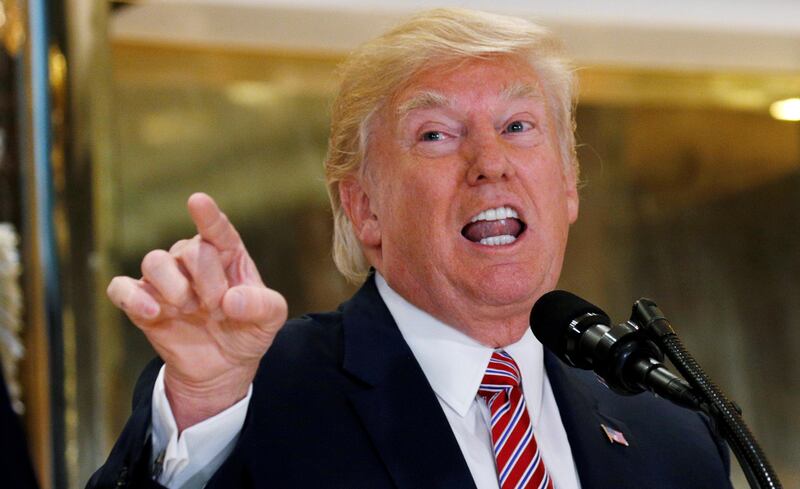 U.S. President Donald Trump answers questions about his response to the violence, injuries and deaths at the "Unite the Right" rally in Charlottesville as he talks to the media in the lobby of Trump Tower in Manhattan, New York, U.S., August 15, 2017.   REUTERS/Kevin Lamarque     TPX IMAGES OF THE DAY