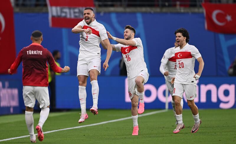 Merih Demiral of Turkey celebrates after scoring his team's first goal with teammates Ismail Yuksek and Ferdi Kadioglu during his side's 2-1 victory over Austria in their Euro 2024 last-16 clash in Leipzig on July 2, 2024. Getty Images