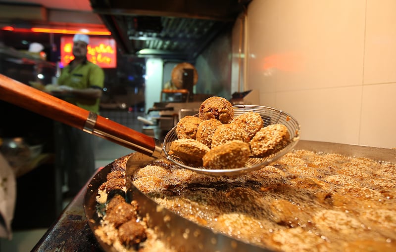 
SHARJAH, UNITED ARAB EMIRATES Ð July 26: Mohamed Ahmed Mustafa from Egypt frying falafel balls at the Foul Wa Falafel restaurant in Sharjah. (Pawan Singh / The National) For News. Story by Afshan
