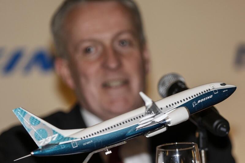 A Boeing 737 MAX miniature aircraft is displayed in front of the Malaysia Airlines chief executive Peter Bellew in Putrajaya, Malaysia. The airline on Wednesday announced a deal with the US plane maker for 50 737 MAX aircraft.  Ahmad Yusni / EP