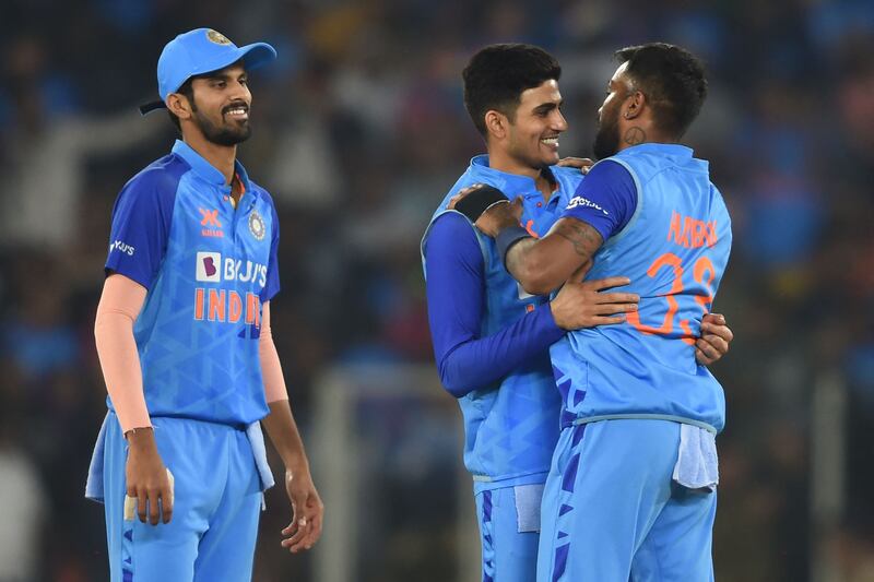 India's Shubman Gill (C) and teammate Hardik Pandya (R) celebrate India's win at the end of the third Twenty20 international cricket match between India and New Zealand at the Narendra Modi stadium in Ahmedabad on February 1, 2023.  (Photo by Punit PARANJPE  /  AFP)  /  ----IMAGE RESTRICTED TO EDITORIAL USE - STRICTLY NO COMMERCIAL USE-----