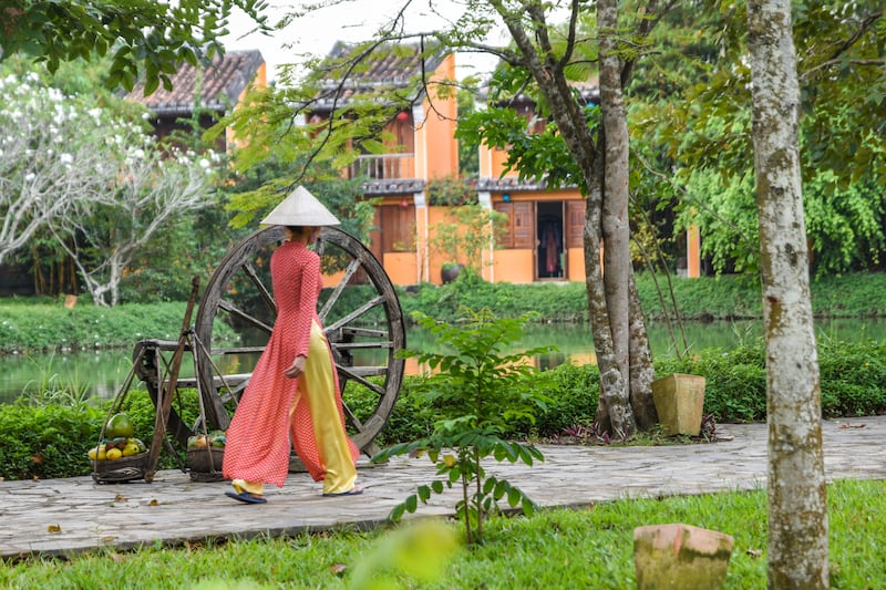 The ao dai, combined with a non la, Vietnam’s famous conical hat, graces most promotional materials for Vietnamese tourism, from guidebooks to posters. Courtesy Ronan O'Connell