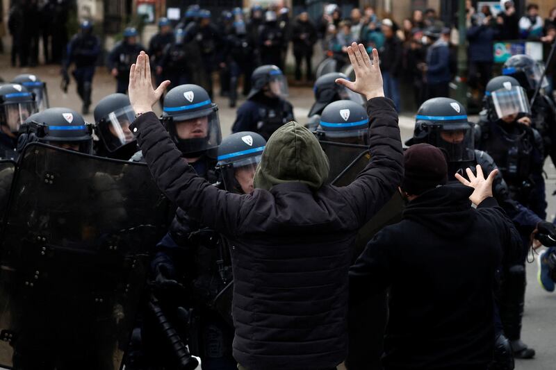 A protester faces off with French riot police amid clashes during a demonstration in Paris. Reuters