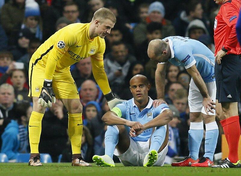 Manchester City’s Vincent Kompany looks dejected after sustaining an injury as Joe Hart and Pablo Zabaleta look on. Action Images via Reuters / Jason Cairnduff