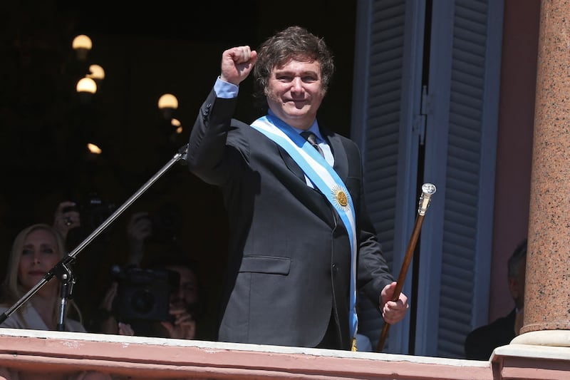 Argentina's new President Javier Milei gestures at the crowd from a balcony of the Casa Rosada government palace during his inauguration day in Buenos Aires. AFP