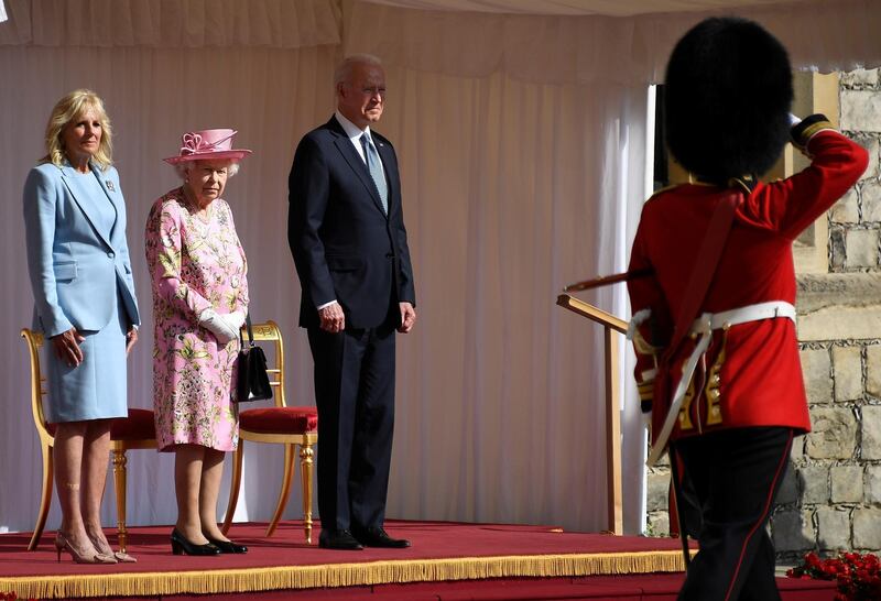 US President Joe Biden takes a salute from a Guard of Honour after arriving with First Lady Jill Biden to meet Britain's Queen Elizabeth II at Windsor Castle. Reuters