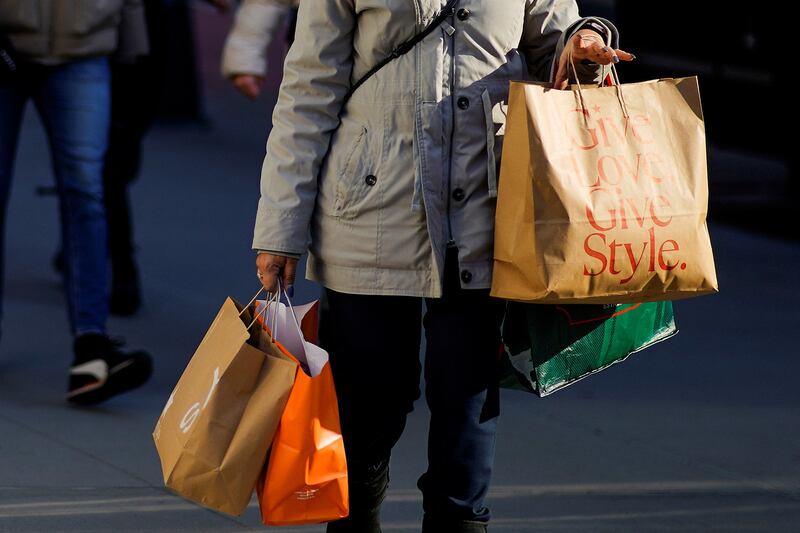 A woman carries shopping bags in New York. American consumer spending has steadily recovered. Reuters