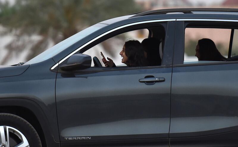(FILES) In this file photo taken on May 13, 2018, a Saudi woman test-drives a car during an automotive exhibition for women in the capital Riyadh. Saudi Arabia, the only country that does not allow women to drive, is set to lift its ban on female motorists on June 24. / AFP / FAYEZ NURELDINE
