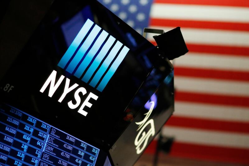 A logo for the New York Stock Exchange is displayed above the trading floor, Wednesday, Dec. 27, 2017. Wall Street delivered big gains and shattered stock market records in 2017 as a global economic rebound, strong company earnings growth and the GOP-led push to slash corporate taxes and enact other pro-business policies encouraged investors to keep buying stocks even as share prices climbed ever higher. (AP Photo/Mark Lennihan)