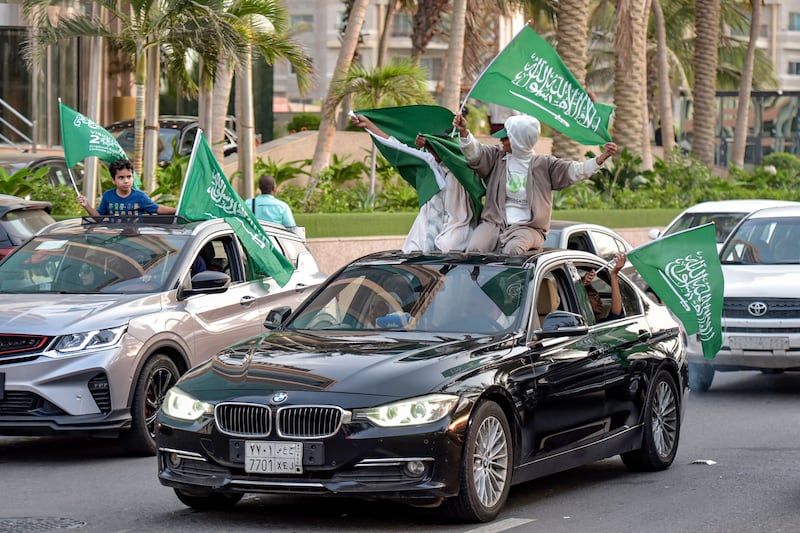 Saudis wave the kingdom's flag from the windows of cars in Riyadh after their team's sensational win.  AFP