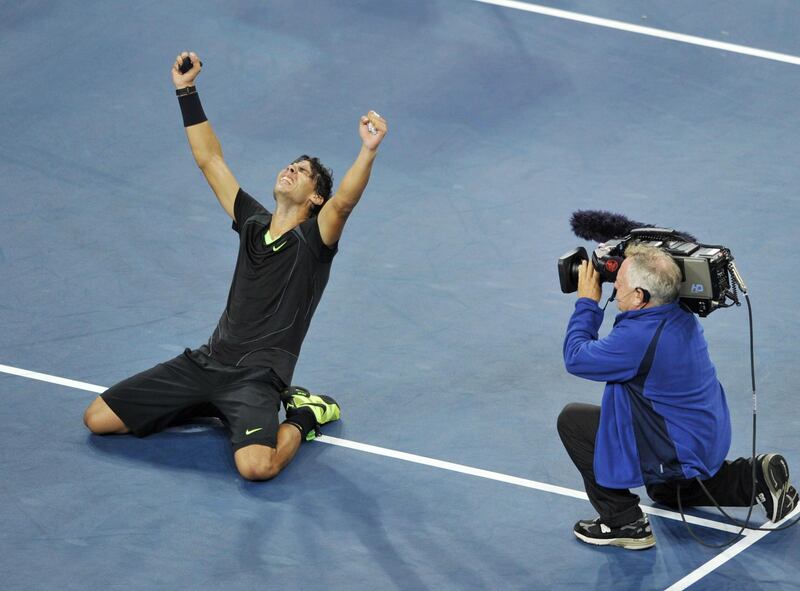 Rafael Nadal of Spain falls to the court as he celebrates his 6-4, 5-7, 6-4, 6-2 win over Novak Djokovic of Serbia in the Men's Finals at the US Open 2010 tennis tournament September 13, 2010 in New York. AFP PHOTO/Stan Honda (Photo by STAN HONDA / AFP)