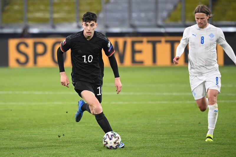 Germany's midfielder Kai Havertz (L) controls the ball during the FIFA World Cup Qatar 2022 qualification football match Germany v Iceland in Duisburg, western Germany on March 25, 2021. (Photo by Ina Fassbender / AFP)