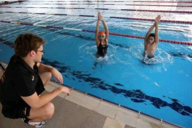 Velimir Stjepanovic, pictured here with Alia Al Shamsi and her brother Abdullah, says there is no excuse not to have world-class swimmers in the UAE.