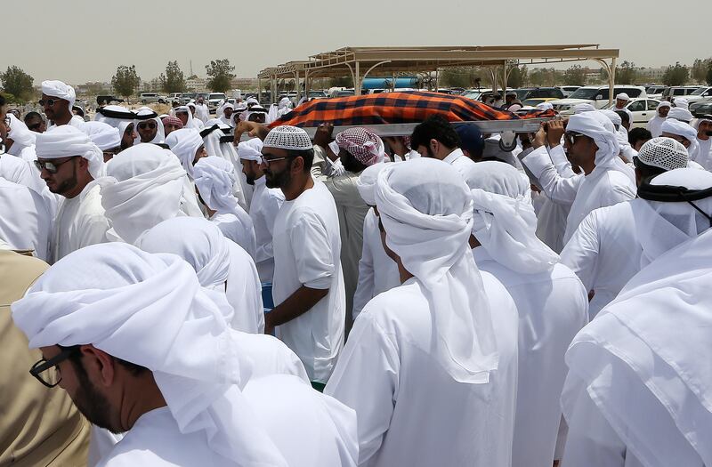 Friends and family carry the body of Khaled Qai, who died in a car accident en route to Salalah on Tuesday, for burial. Pawan Singh / The National 