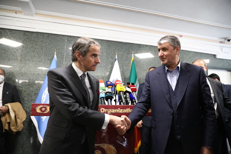 Iran's civilian nuclear chief Mohammad Eslami and IAEA head Rafael Grossi shake hands in Tehran. Reuters